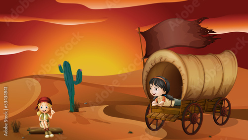 A girl lying inside the carriage and a girl sitting on a wood