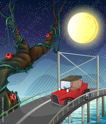 A vintage car passing across the bridge