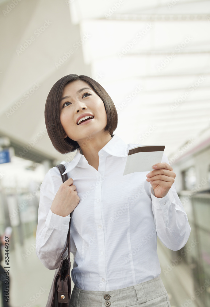 Young Woman Holding a Train Ticket Young Woman Holding a Train Ticket