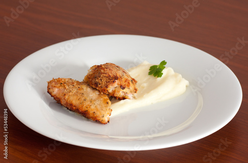 chicken covered with cracker crumbs with potato mash