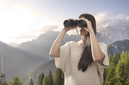 Young woman watching with binocular