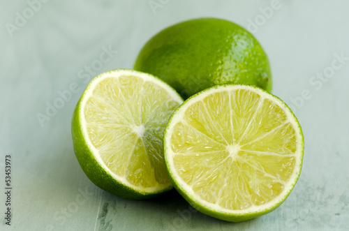 Limes in a green wooden background © pat_hastings