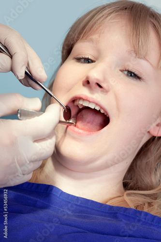 Woman having the teeth examined by the dentist.