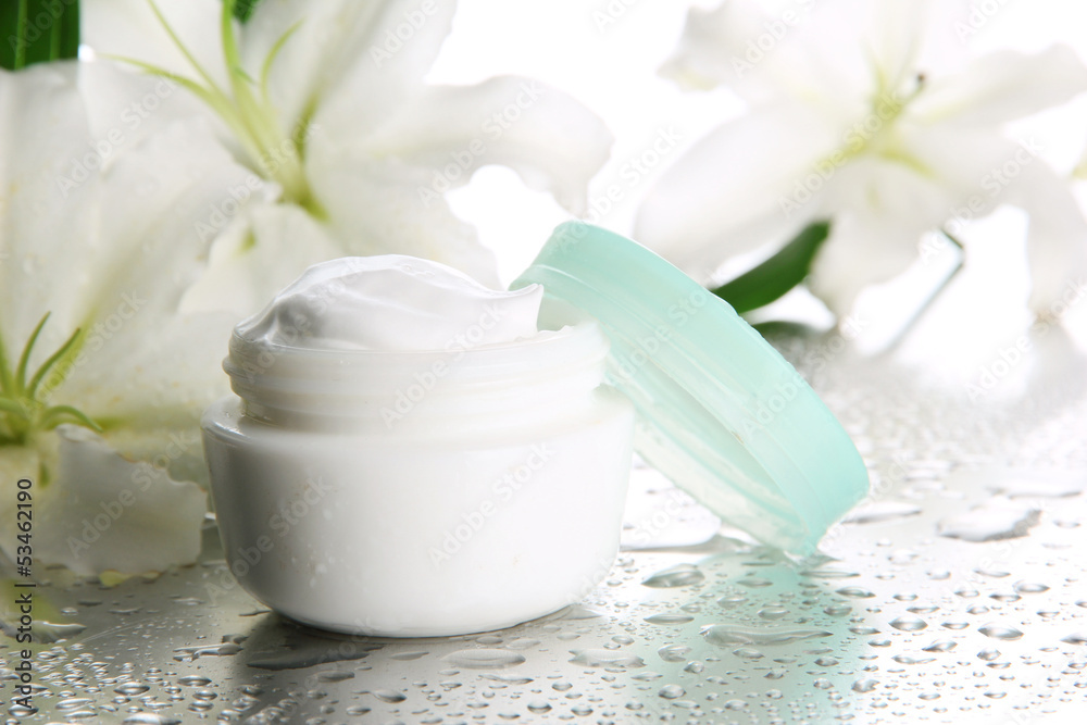 Cosmetic cream and beautiful lily, close up Cosmetic cream and beautiful lily, close up