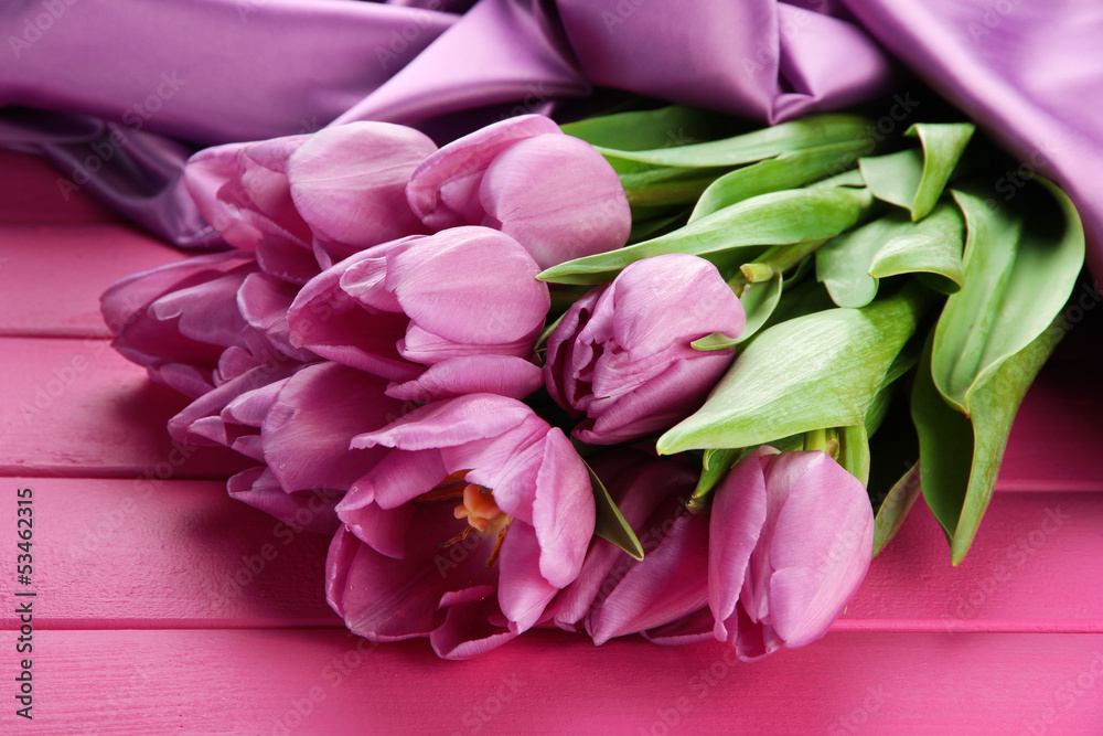 Beautiful bouquet of purple tulips on pink wooden background Beautiful bouquet of purple tulips on pink wooden background