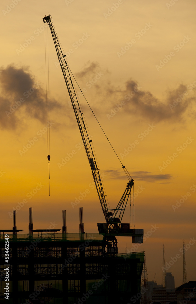 crane of building construction on dusky sky