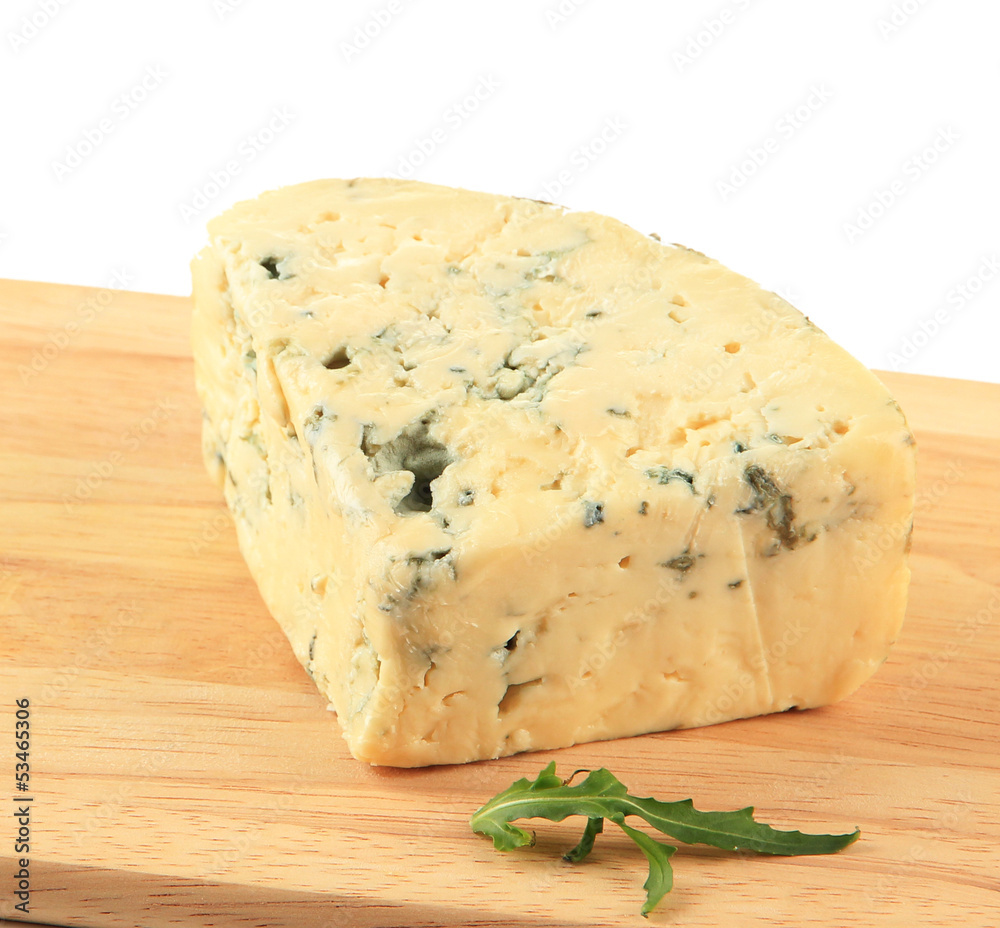 Tasty blue cheese on cutting board, isolated on white Tasty blue cheese on cutting board, isolated on white