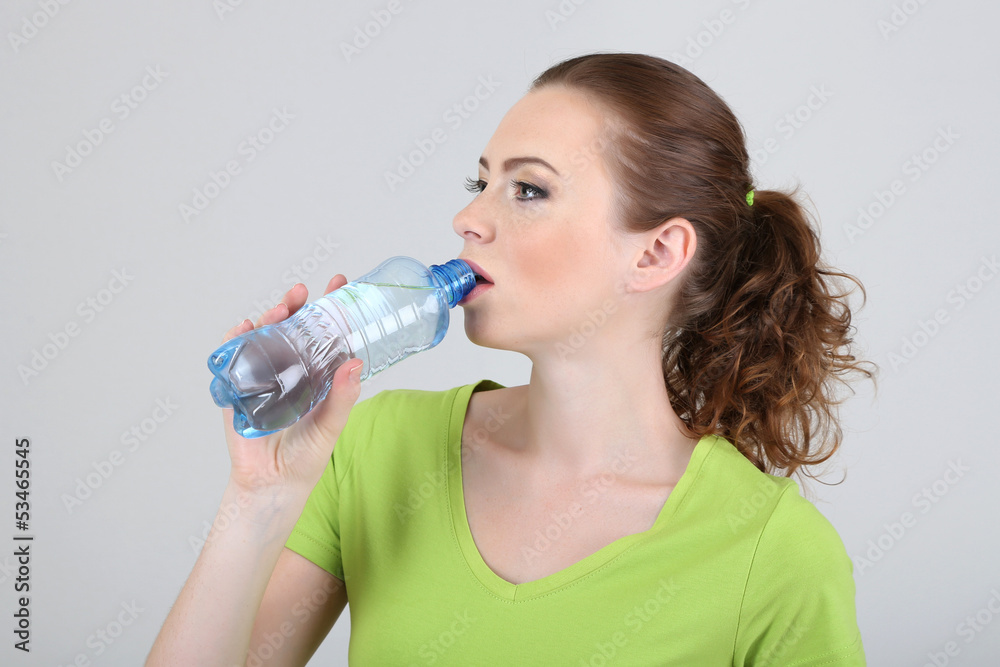Beautiful young woman with bottle of water Beautiful young woman with bottle of water