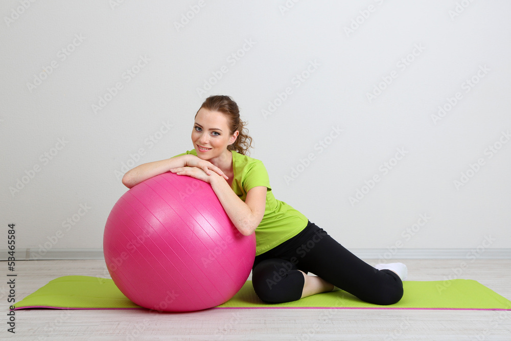 Portrait of beautiful young woman exercises with gym ball Portrait of beautiful young woman exercises with gym ball