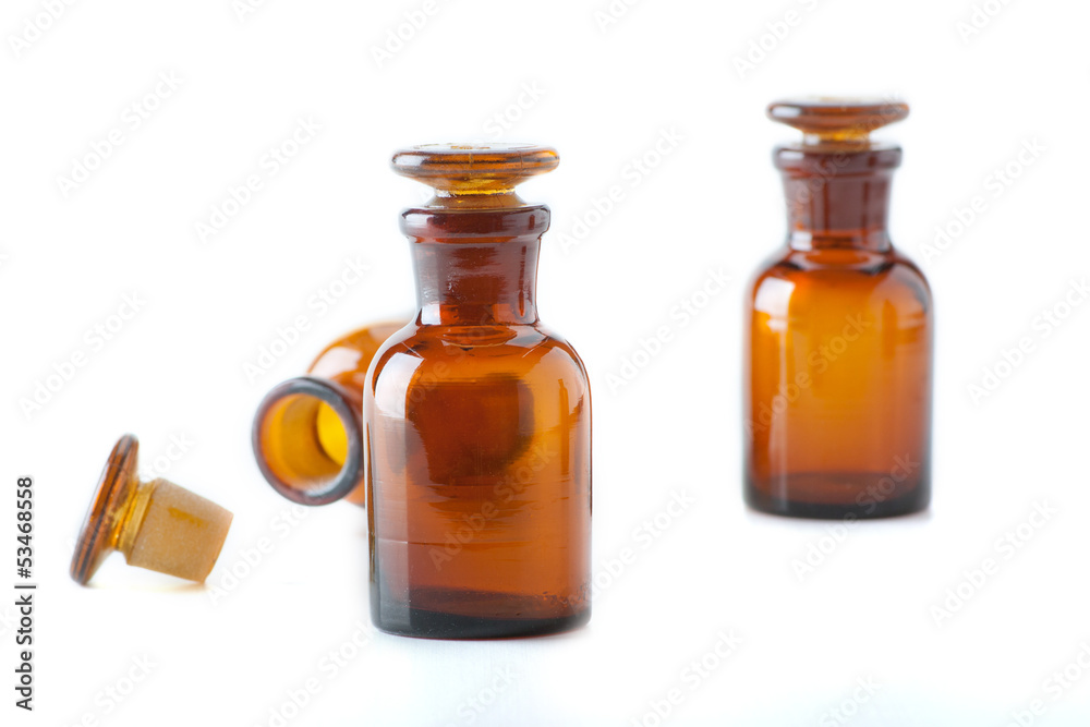 Small chemical glass bottles on white background