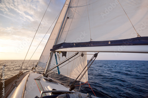 Sailing on yacht at sunset