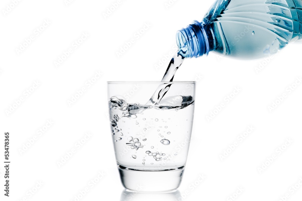 pouring a glass with water trough little blue bottle pouring a glass with water trough little blue bottle