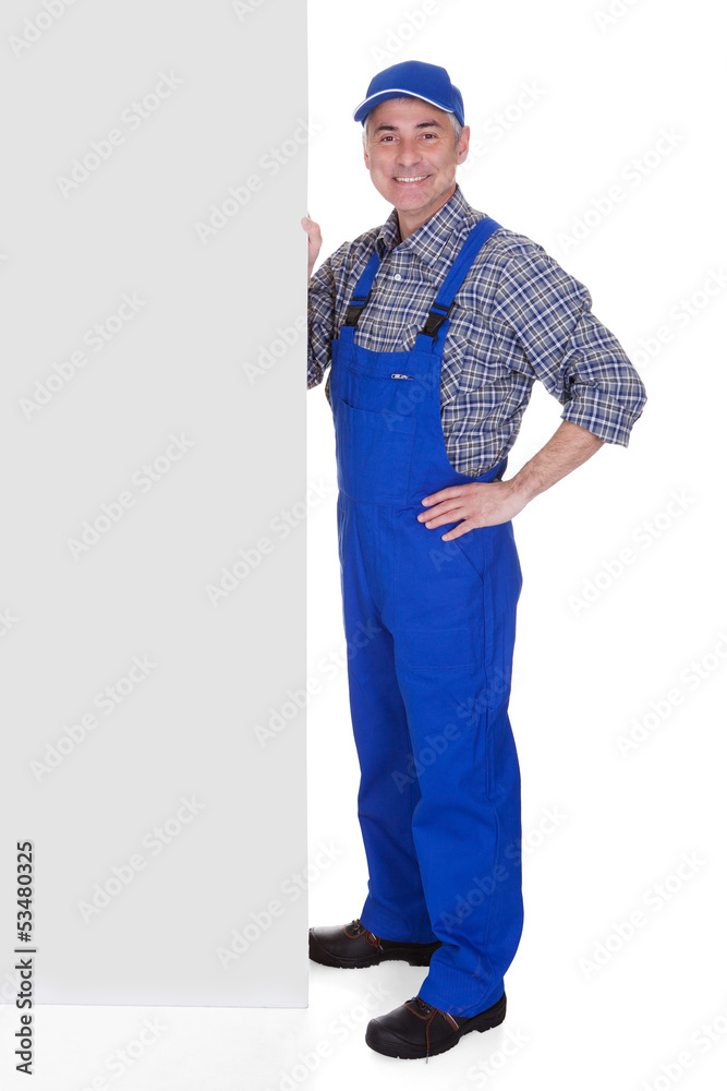 Mature Male Technician Pointing On Placard Mature Male Technician Pointing On Placard