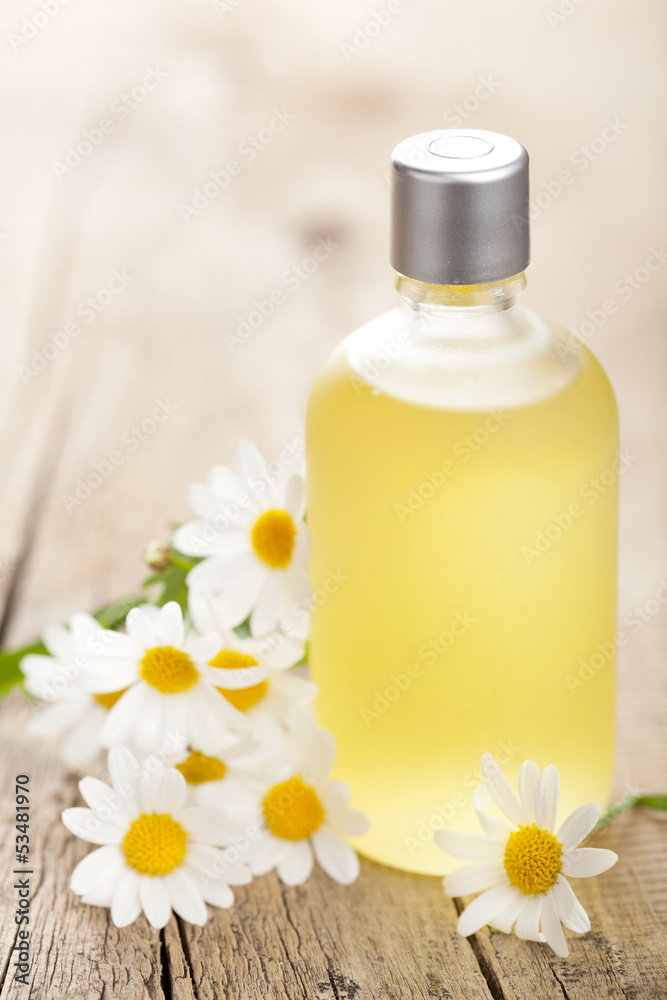 essential oil and chamomile flowers
