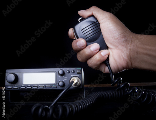 hand of Amateur radio holding speaker and press photo