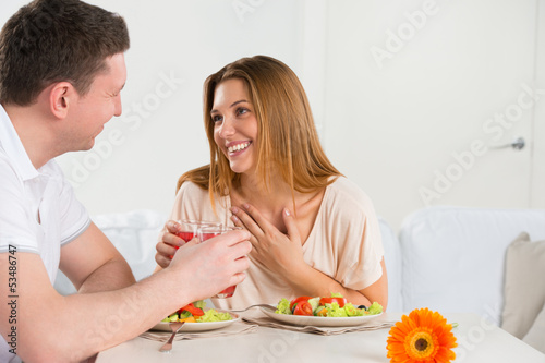Happy couple eating vegetable salad