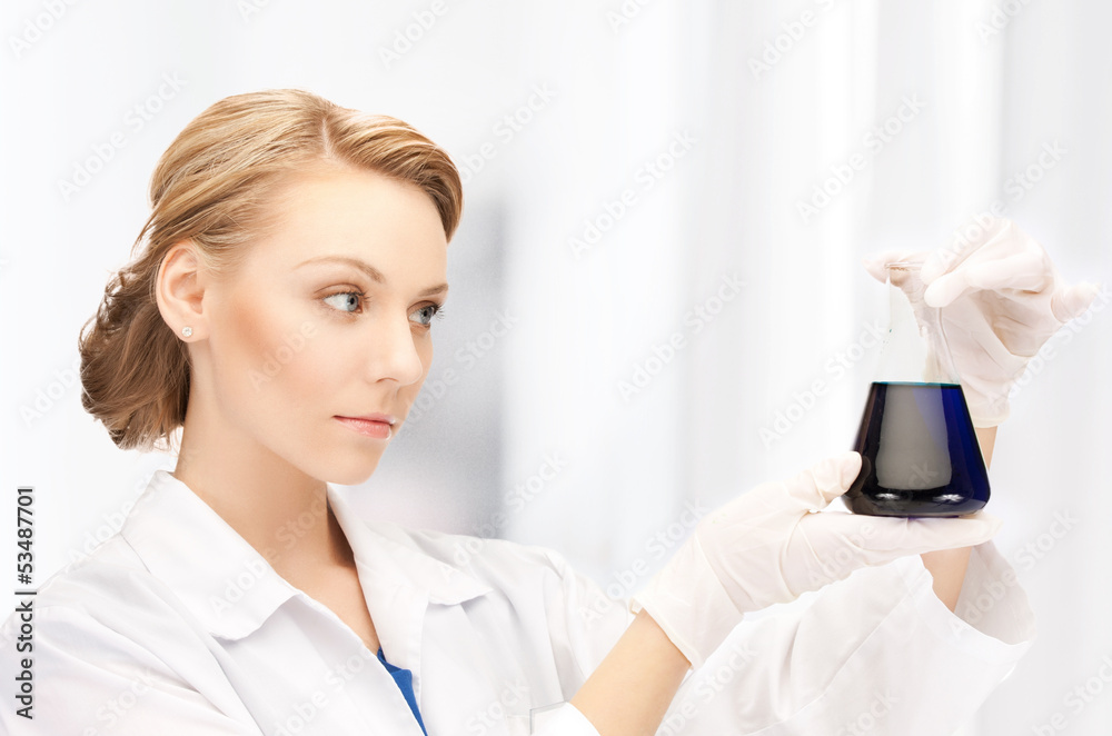 female chemist holding bulb with chemicals female chemist holding bulb with chemicals
