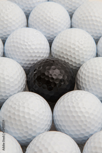 White and black golf balls in the box