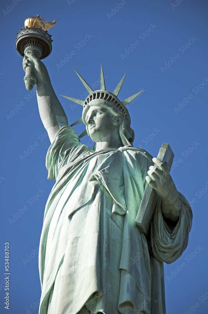 Fototapeta premium Statue of Liberty closeup blue sky background