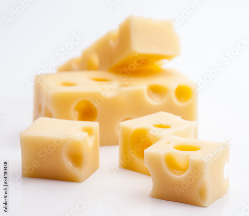 Emmental cheese portions on white base photo