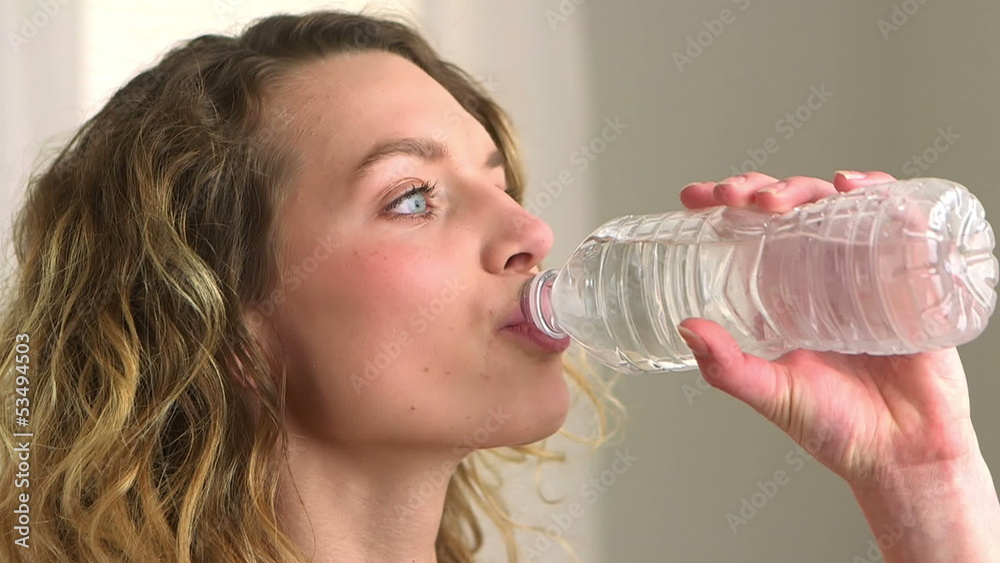 Close-up of blonde woman drinking bottled water Close-up of blonde woman drinking bottled water