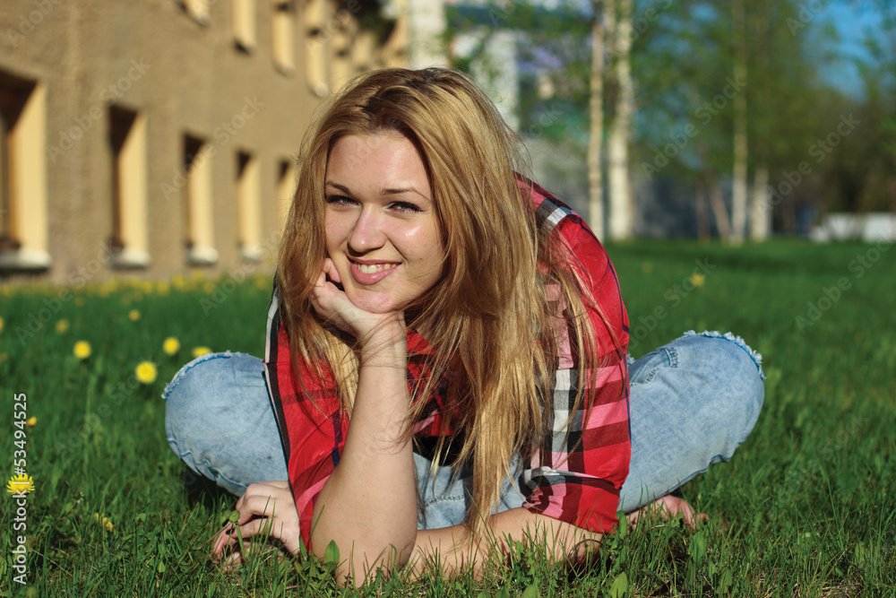 Fototapeta premium Happy smiling girl on the grass