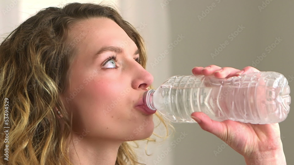 Close-up of blonde woman drinking bottled water Close-up of blonde woman drinking bottled water