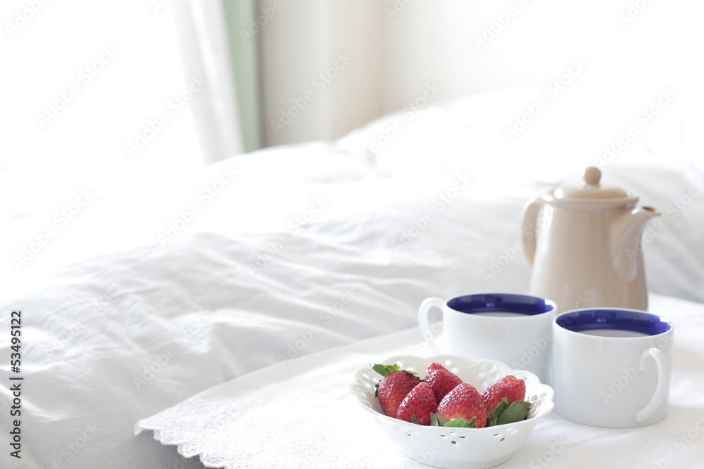 coffee and strawberry on bed side for home interior image
