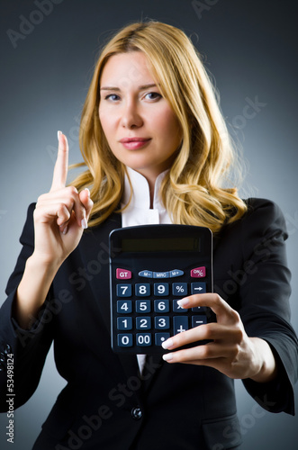 Businesswoman with calculator in business concept