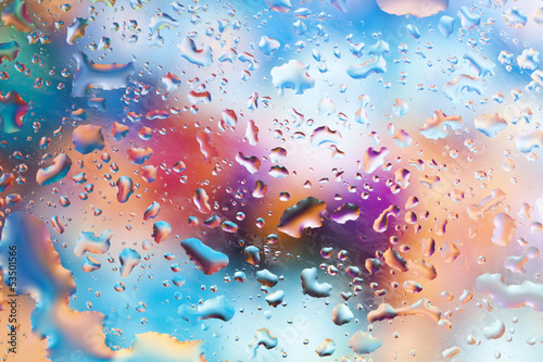 Fresh background of water drops on colorful surface