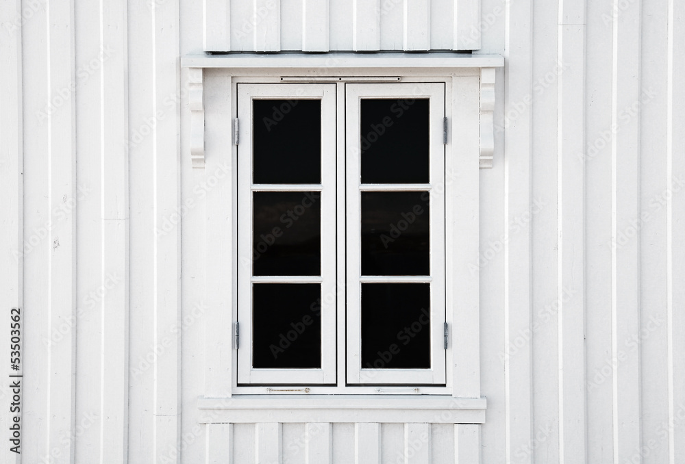 Window in white wooden wall. Norway architecture