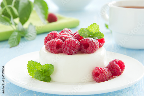 Vanilla panna cotta with raspberries. photo