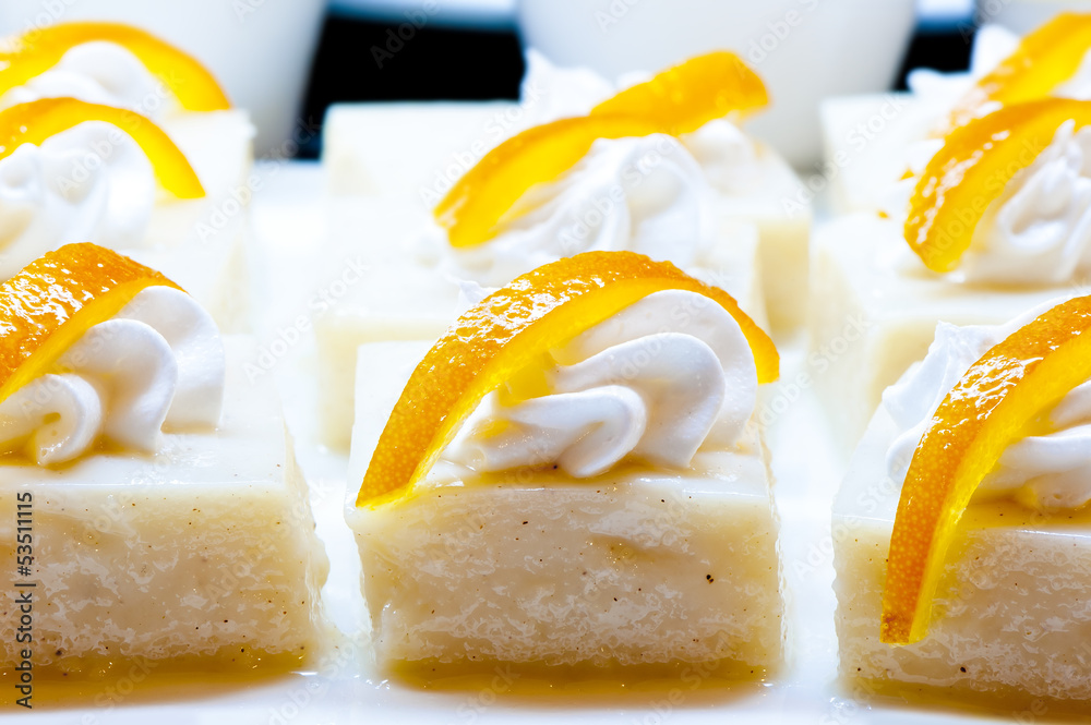 Fototapeta premium White dessert garnished with whipped cream and zest