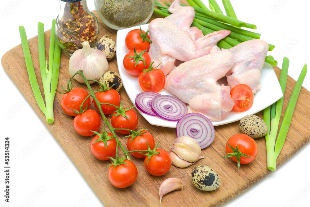 vegetables and raw chicken wings closeup vegetables and raw chicken wings closeup