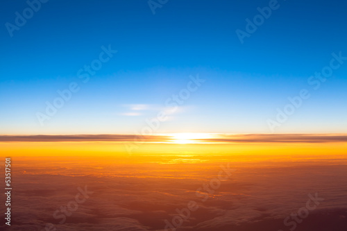 Dramatic sunset. View of sunset above clouds from airplane wind
