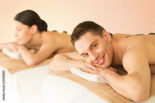 couple in spa with hot stones