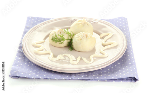 Tasty khinkali on plate, isolated on white