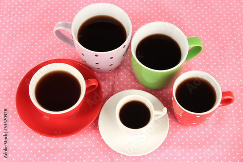 Cups of coffee on pink napkin