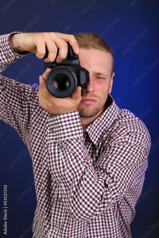 Handsome photographer with camera,on dark color background Handsome photographer with camera,on dark color background