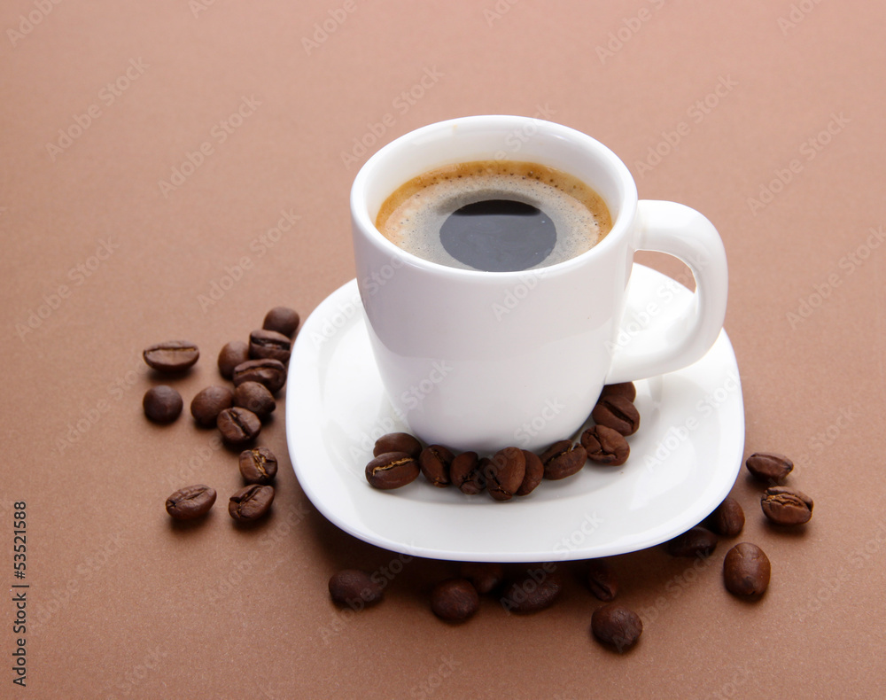 Cup of coffee with coffee beans on brown background Cup of coffee with coffee beans on brown background