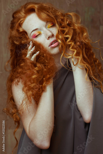 Fotografie Portrait of red-haired girl with long hair