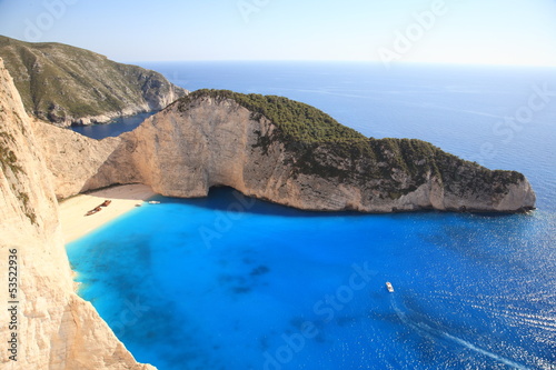 beautiful white beach with shipwreck in a greek island