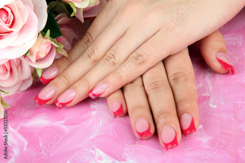 Closeup of hands of young woman with elegance manicure,