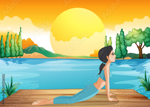 A girl performing yoga along the river