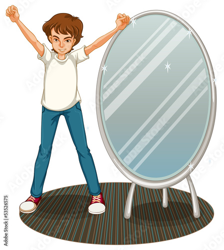 A boy beside a mirror