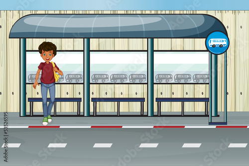 A boy at the bus stop