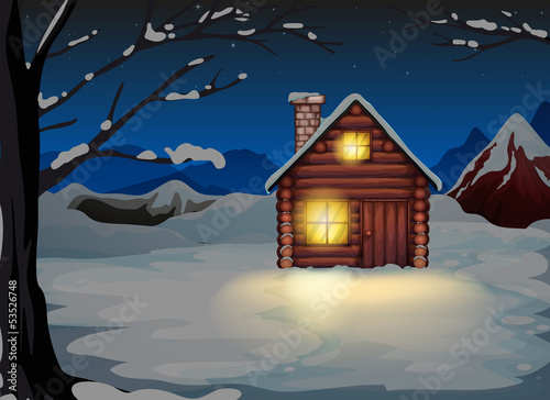 A lighted log house at the snowy land