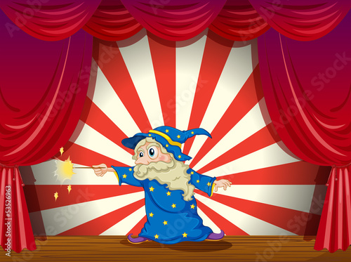 A wizard with a wand in the middle of the stage