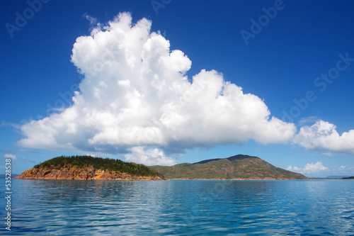 White cloud hovering over island