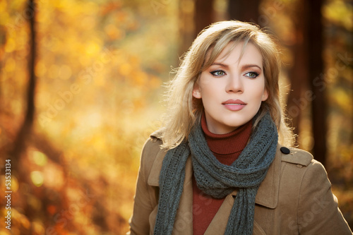 Blond woman in autumn forest